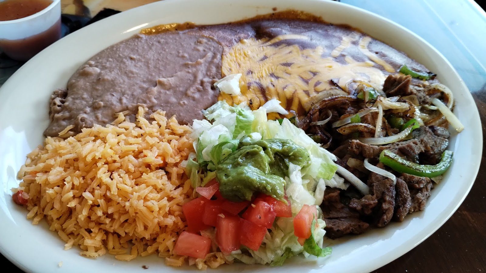 Beef fajita platter with rice, beans and guacamole
